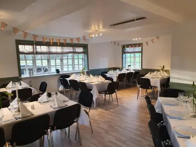a room with tables and chairs with white tablecloths at Danhostel Rebild in Skorping