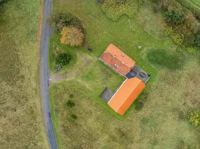 an overhead view of a house in a field at Large Pool House With Activity Room Located In Peaceful Surroundings in Frøstrup