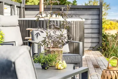 a wicker vase sitting on a table on a patio at Lovely Spa House In Scenic Surroundings in Thyholm