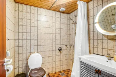 a bathroom with a toilet and a sink and a shower at Large Holiday Home With A View Of The Fjord in Thyholm
