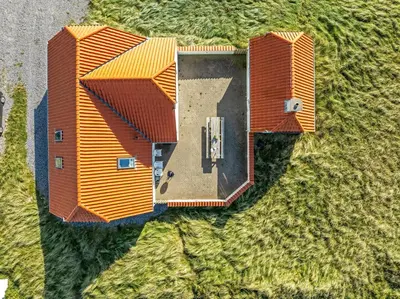 an overhead view of a house with orange roof at Pool And Activity House With A Fantastic View Of The North Sea in Frøstrup