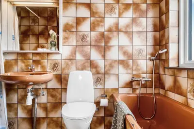 a bathroom with a toilet and a sink and a tub at Lovely Holiday Home With Panoramic Views Of The North Sea in Frøstrup