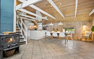 a kitchen and living room with a stove and a table at Cozy Home In Spøttrup With Wifi in Spottrup