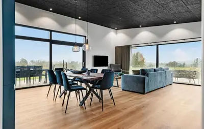 a dining room with a table and chairs and a couch at 3 Bedroom Stunning Home In Løgstrup in Løgstrup
