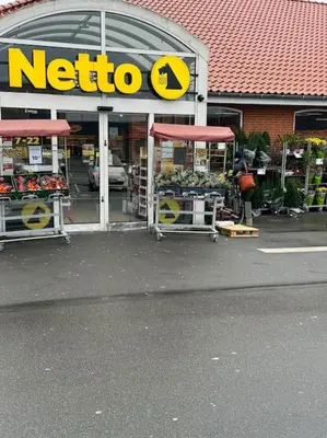 a store with a nato sign on the front of it at Stor og Lys Lejlighed i Hjertet af Holstebro in Holstebro