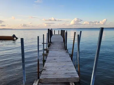 a wooden dock in the middle of the water at 8 person holiday home in Roslev in Roslev