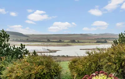 a view of a field with mountains in the background at Cozy Home In Hanstholm With Wifi in Hanstholm