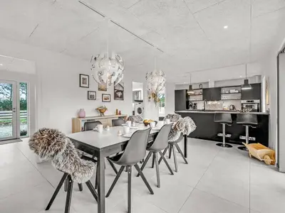 a kitchen and dining room with a table and chairs at Holiday Home Elisaveta - 400m to the fjord by Interhome in Vemb