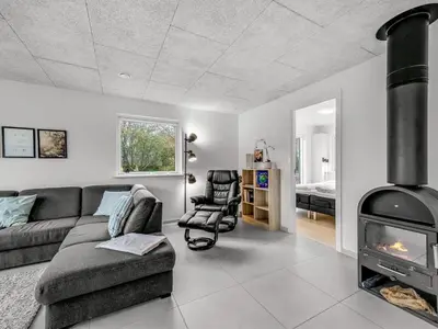 a living room with a couch and a fireplace at Holiday Home Elisaveta - 400m to the fjord by Interhome in Vemb