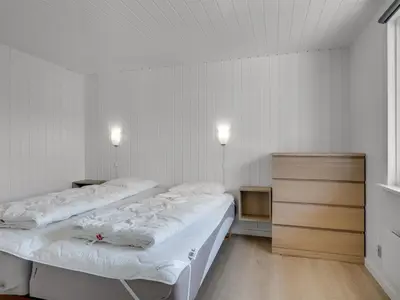 two beds in a white room with two lights on at Holiday Home Eftim - 500m from the sea by Interhome in Harboør