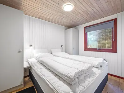 a large bed in a room with a window at Holiday Home Ennignup - 600m to the fjord by Interhome in Højslev