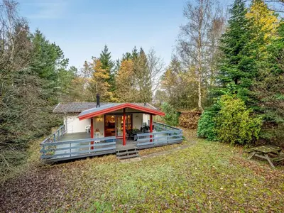 a tiny house in the woods with a red roof at Holiday Home Ennignup - 600m to the fjord by Interhome in Højslev