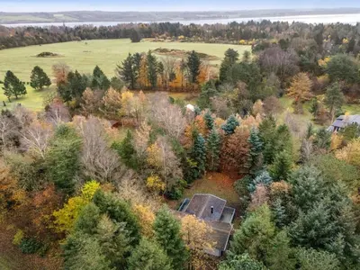 an old house in the middle of a field with trees at Holiday Home Ennignup - 600m to the fjord by Interhome in Højslev