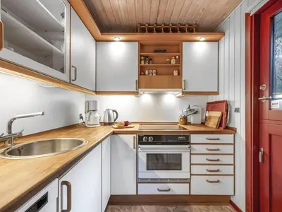 a kitchen with white cabinets and a sink at Holiday Home Ennignup - 600m to the fjord by Interhome in Højslev