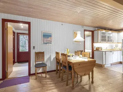 a kitchen and dining room with a table and chairs at Holiday Home Ennignup - 600m to the fjord by Interhome in Højslev