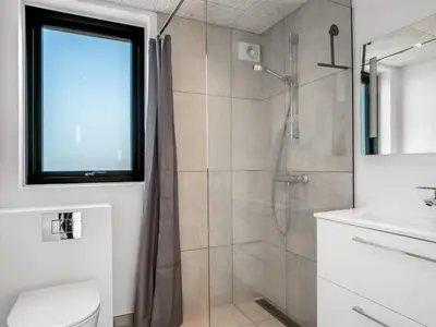 a bathroom with a shower and a sink at Holiday Home Stenkil - 1-2km from the sea by Interhome in Løkken