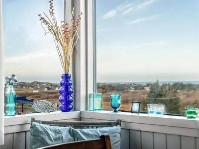 a window with vases sitting on a window sill at Holiday Home Sella - 600m from the sea by Interhome in Blokhus