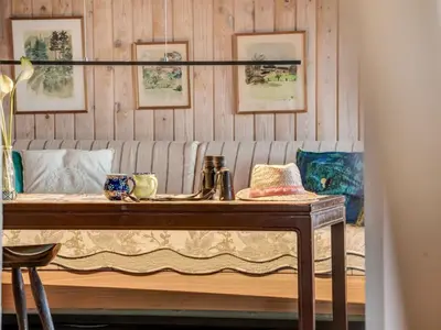 a table with a couch in a room at Holiday Home Sella - 600m from the sea by Interhome in Blokhus