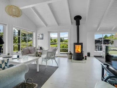 a living room with a fireplace and a couch at Holiday Home Ljupco - 950m from the sea by Interhome in Saltum