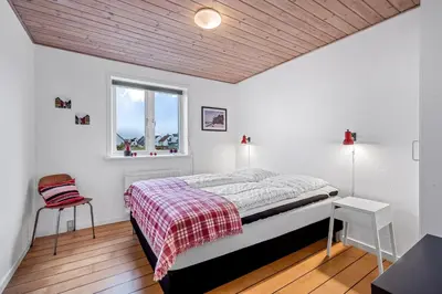 a bedroom with a bed and a window at Lovely Holiday House With 4 Rooms Close To The North Sea in Frøstrup
