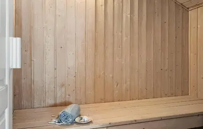 a sauna with a wooden paneled wall and a wooden tub at Beautiful Home In Vestervig With Sauna in Vestervig