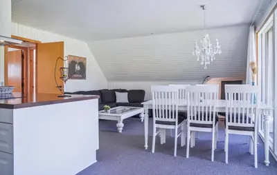 a dining room with a white table and white chairs at 2 Bedroom Amazing Home In Spøttrup in Spottrup