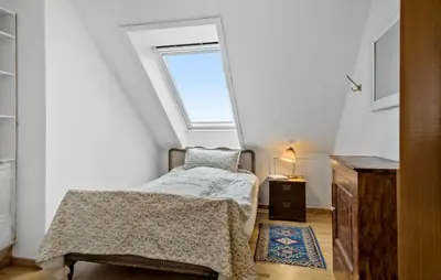 a small bedroom with a bed and a window at 5 Bedroom Lovely Home In Bøvlingbjerg in Bøvlingbjerg
