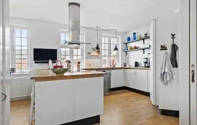 a kitchen with white cabinets and a white refrigerator at 5 Bedroom Lovely Home In Bøvlingbjerg in Bøvlingbjerg