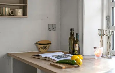 a kitchen counter with a book and a bottle of wine at Pet Friendly Home In Karby in Karby