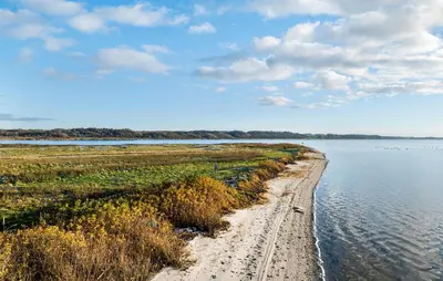 a dirt road next to a body of water at 3 Bedroom Cozy Home In Nibe in Nibe