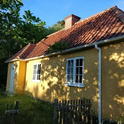 a yellow house with a red roof at Charming Summer House From 1945 in Sønder Ydby