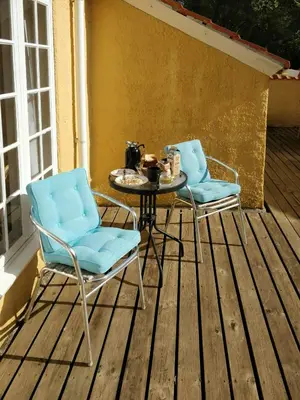 two chairs and a table on a deck at Charming Summer House From 1945 in Sønder Ydby