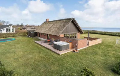 a house with a large yard with a hot tub at Amazing Home In Lemvig in Lemvig