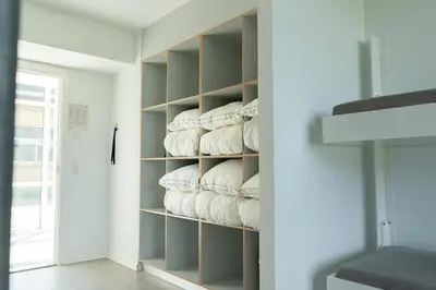 a room with a bunch of pillows on shelves at Jetsmark Idrætscenter in Pandrup