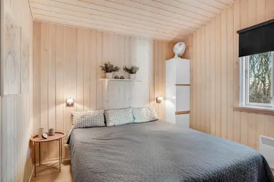 a bedroom with a bed in a small room at Beautiful Holiday Home With A Lovely View Of The Fjord And The Sea in Vestervig