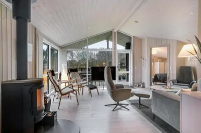 a living room with a fireplace and a couch at Lovely Holiday Home With Wilderness Bath And Space For 8 People in Pandrup