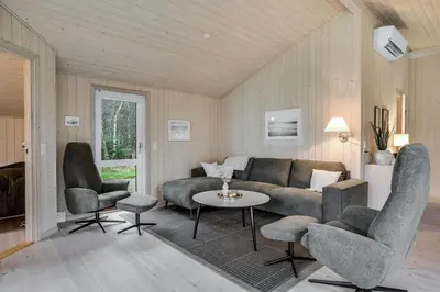a living room with a couch and chairs and a table at Lovely Holiday Home With Wilderness Bath And Space For 8 People in Pandrup
