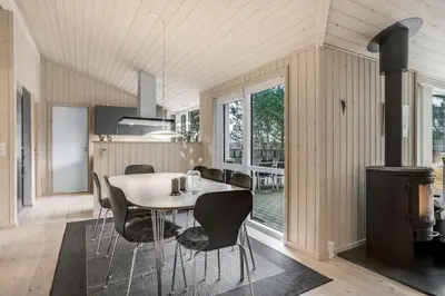 a kitchen and dining room with a table and chairs at Lovely Holiday Home With Wilderness Bath And Space For 8 People in Pandrup