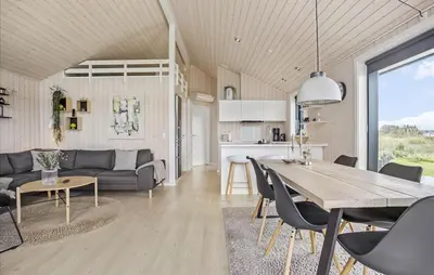 a kitchen and living room with a table and chairs at Amazing Home In Fjerritslev in Fjerritslev
