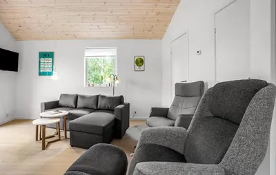 a living room with a couch and chairs and a table at 2 Bedroom Amazing Home In Hurup Thy in Sønder Ydby