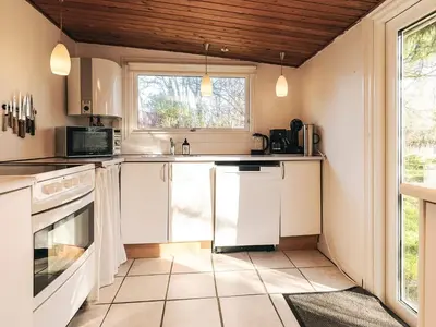 a kitchen with white appliances and a window at 6 person holiday home in Nibe in Nibe