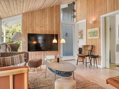 a living room with a couch and a table at Holiday Home Elisenda - 2-2km from the sea by Interhome in Blokhus