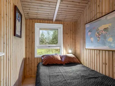 a bedroom with a bed in a room with a window at Holiday Home Gonda - 2km from the sea by Interhome in Saltum