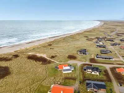 an aerial view of a beach with houses and the ocean at Holiday Home Amina - 50m from the sea by Interhome in Torsted