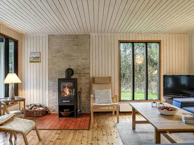 a living room with a fireplace and a tv at Holiday Home Star - 600m from the sea by Interhome in Løkken