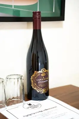 a bottle of wine sitting on top of a table at Villa Apartments Viborg in Viborg