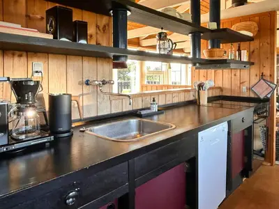 a kitchen with a sink and a counter top at Architect-Designed Summer House In Agger in Vestervig
