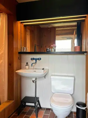 a bathroom with a toilet and a sink at Architect-Designed Summer House In Agger in Vestervig