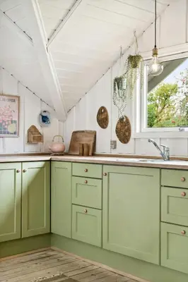 a kitchen with green cabinets and a window at Home By Limfjord Where Sea And Sky Meet in Hurup