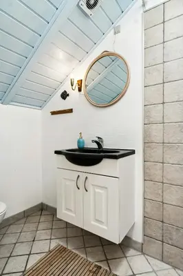a bathroom with a sink and a mirror at Home By Limfjord Where Sea And Sky Meet in Hurup